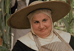 a woman wearing a straw hat and a striped apron