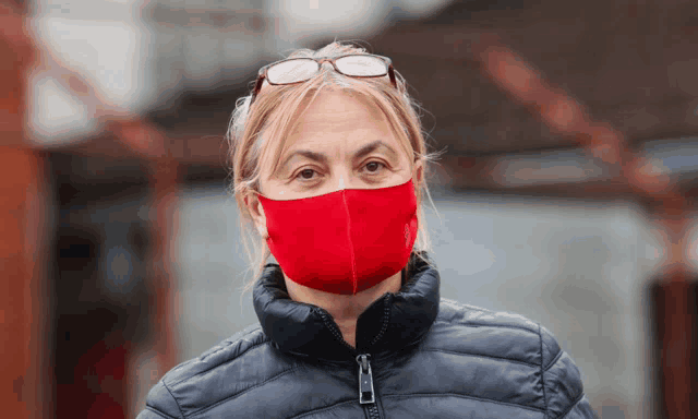 a woman wearing a red mask and glasses