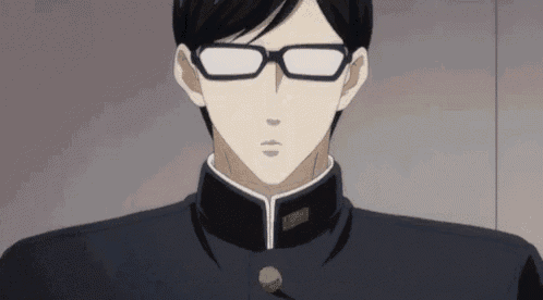 a man wearing glasses and a black uniform is looking at the camera .
