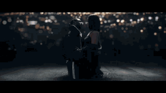 a man and a woman kissing in a dark room