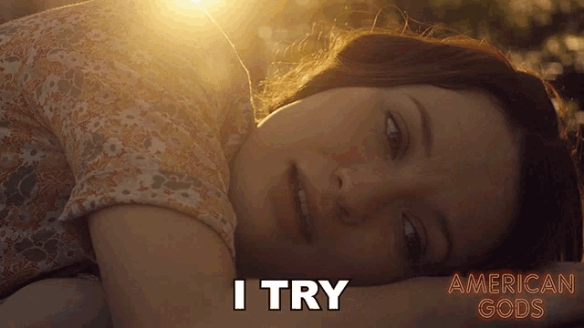 a poster for american gods shows a woman laying down with the words i try above her