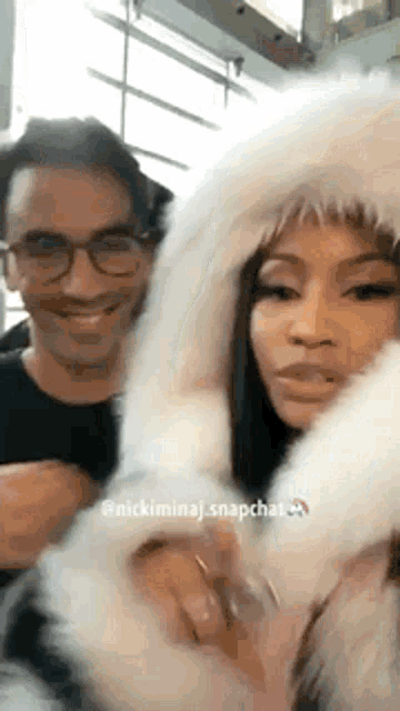a man and a woman are standing next to each other in a fur coat .