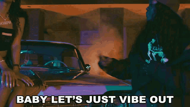 two women dancing in front of a car with the words baby let 's just vibe out below them
