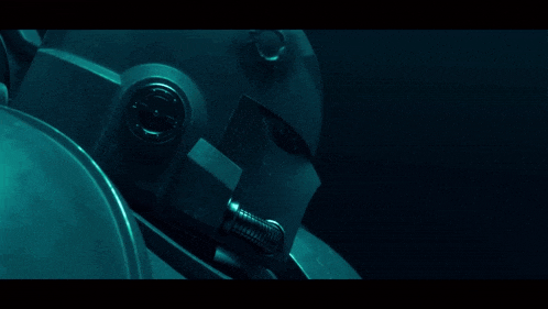 a close up of a robot 's helmet with a red eye
