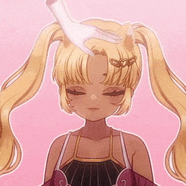 a hand is touching a girl 's head with a heart shaped hair clip