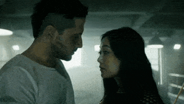 a man and a woman are looking into each other 's eyes .