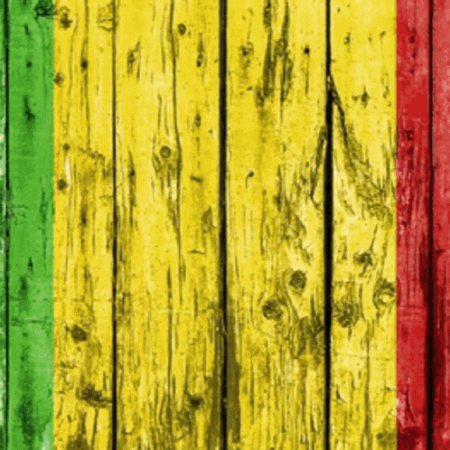 a wooden wall with yellow red and green painted on it