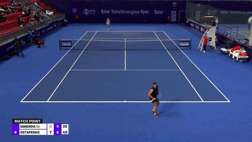 a woman holding a wilson tennis racquet in front of a scoreboard that says match point