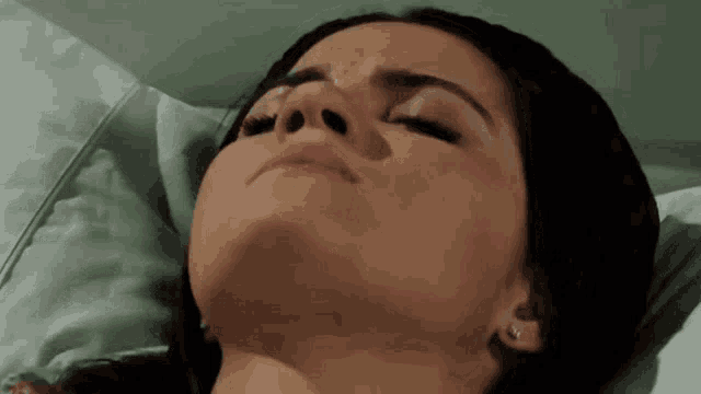 a close up of a woman laying in bed