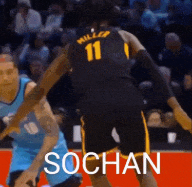 a basketball player with the number 11 on his jersey is playing basketball against another player .