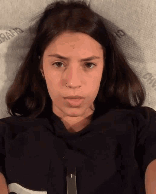 a woman laying on a bed with a mattress that says chanel on it