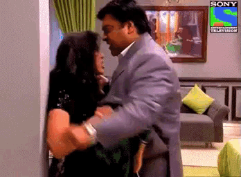 a man and a woman are hugging in a room with a sony logo on the wall