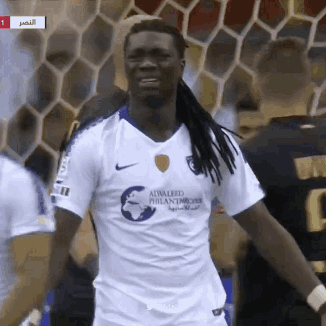 a soccer player wearing a shirt that says ' alwaleed philanthropy ' on it