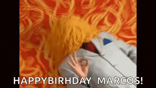 a man in a suit and tie is laying on a bed with spaghetti on his face .