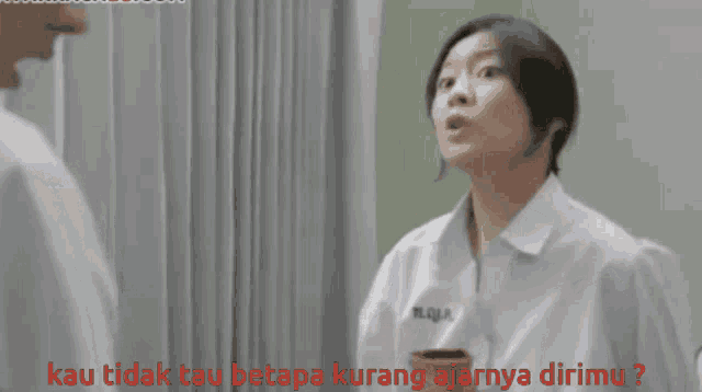 a woman in a white shirt is talking to a man and the words kau tidak tau betapa kurang ajarnya dirimu are visible