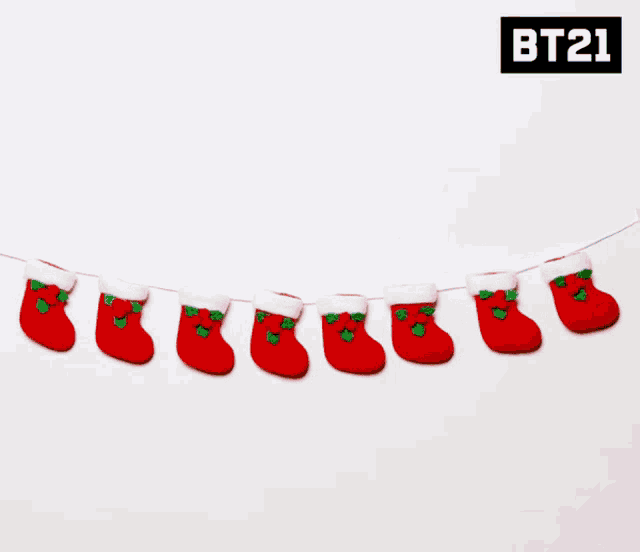 a row of christmas stockings with bt21 written on the bottom