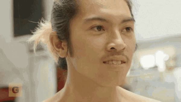 a close up of a man 's face with the letter g visible