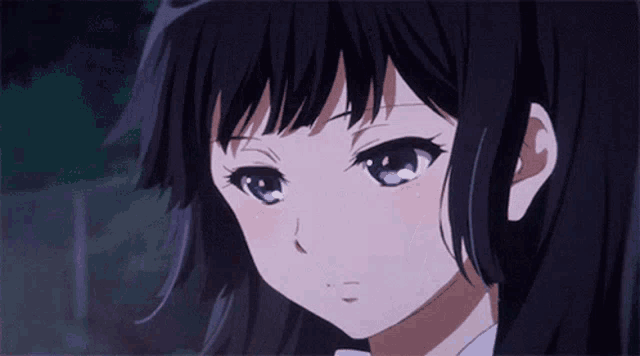 a girl with black hair and purple eyes is looking at the camera