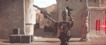 a robot is holding a gun in a desert landscape .