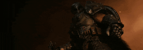 a person in a dark room with a shield on their head