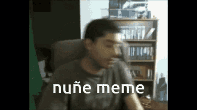 a man is sitting in a chair with the words nuñe meme written on his face
