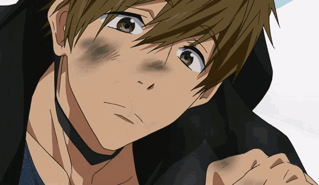 a close up of a boy with green eyes and a black jacket