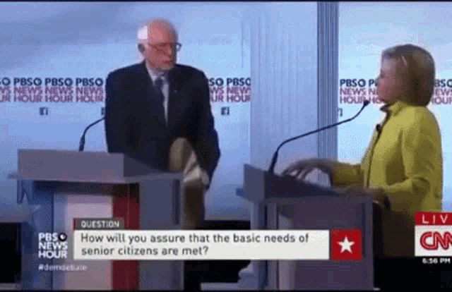 a man and a woman are standing at a podium with microphones and a question about the basic needs of seniors