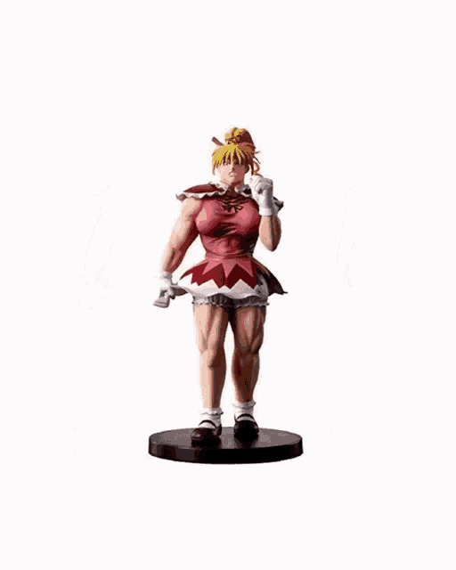 a statue of a girl with blonde hair and a pink dress