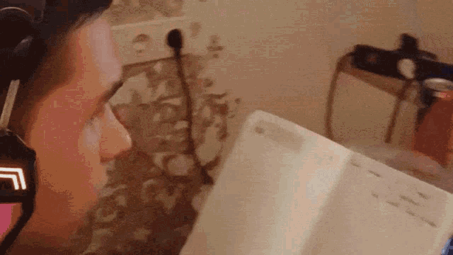 a person wearing headphones reading a book