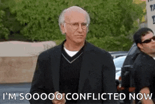 a man in a suit and glasses is standing in a parking lot and saying `` i 'm soooo conflicted now ''