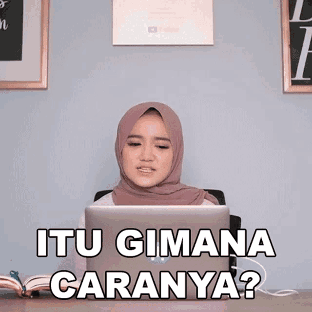 a woman in a hijab sits in front of a laptop with the words itu gimana caranya written on the screen