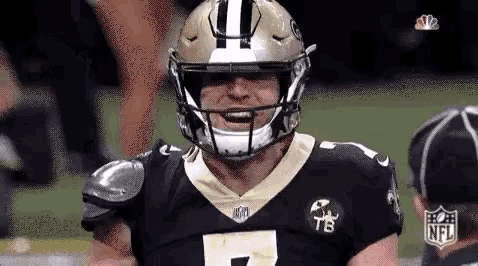 a close up of a football player wearing a helmet and a jersey on a field .