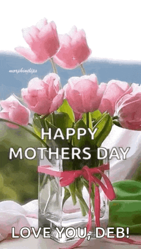 a vase filled with pink flowers with the words `` happy mother 's day love you deb '' written on it .
