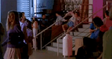 a group of people are standing on a set of stairs in a dark room