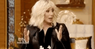 a woman with blonde hair is wearing a black jacket and making a funny face .