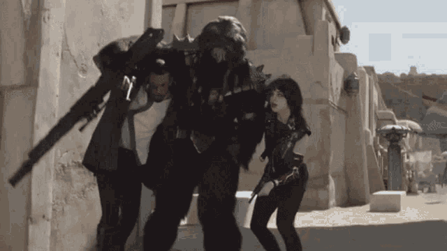 a man and a woman are walking down a street with a robot .