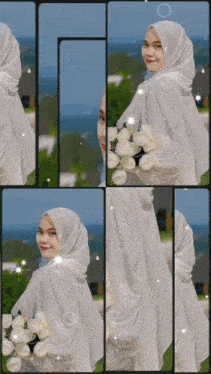 a woman in a white dress and hijab is holding a bouquet of white roses