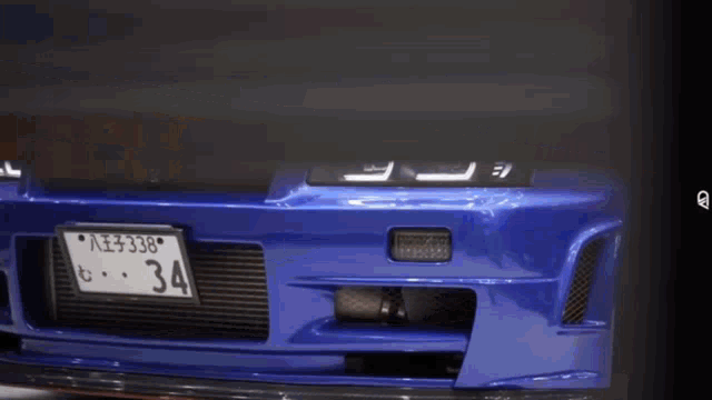 a blue car has a license plate that says 34 on it