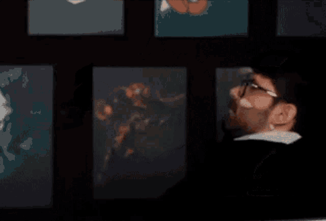 a blurry picture of a person looking at a painting