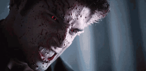 a close up of a vampire 's face with blood on it .
