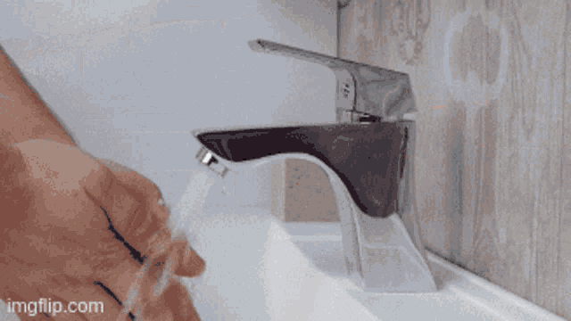 a person is washing their hands in a bathroom sink with imgflip.com written on the bottom