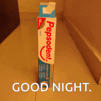 a box of pepsodent toothpaste sits on a tiled floor