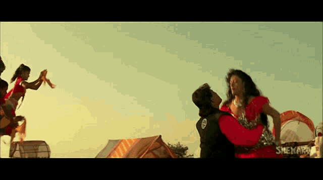 a man is holding a woman in his arms in a scene from a movie