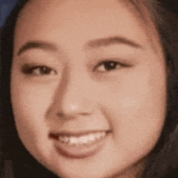 a close up of a woman 's face with her tongue hanging out .