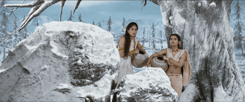 two women standing next to each other in the snow holding pots