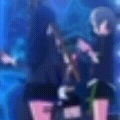 a blurry picture of a person standing on a stage in front of a blue background .