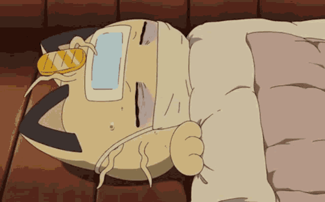 a cartoon cat is laying on the floor with a bandage on his head