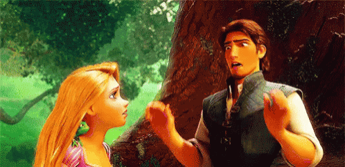 a man and a woman are standing next to each other in a forest .