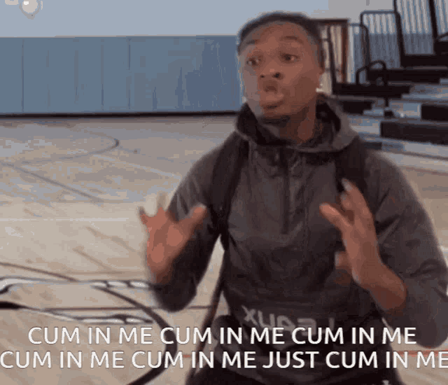 a man standing on a basketball court with the words cum in me cum in me cum in me cum in me just cum in me