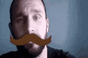 a man with a beard is wearing a fake mustache on his face .
